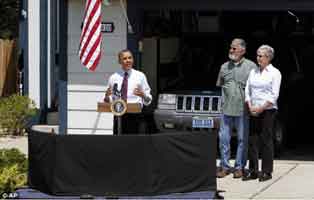 Obama speaks at somebody's garage. AP photo.