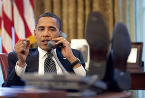 Obama with his feet on the Oval Office desk